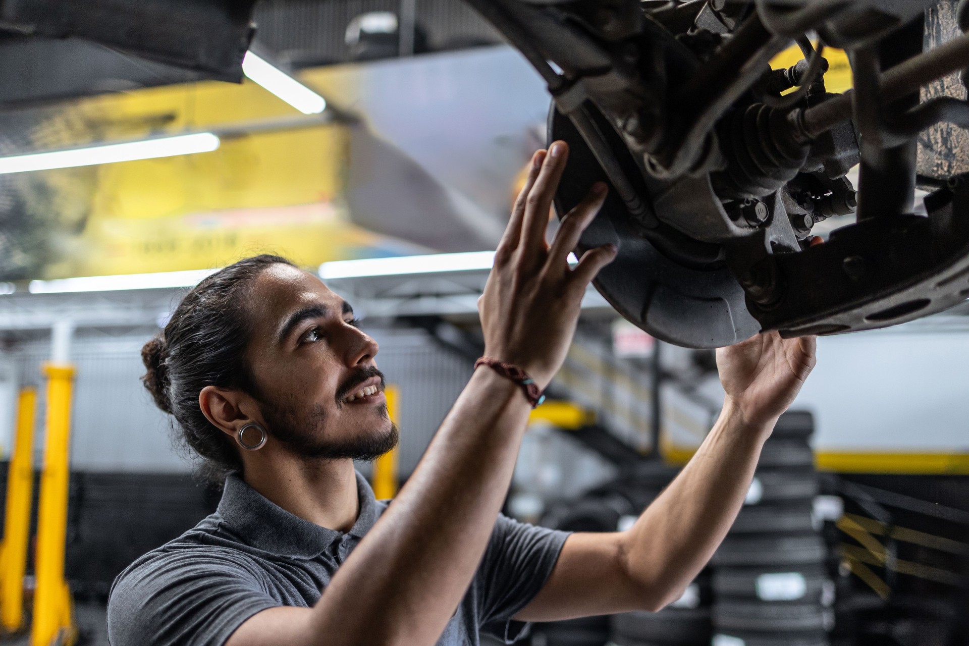 Man servicing a car brake disk