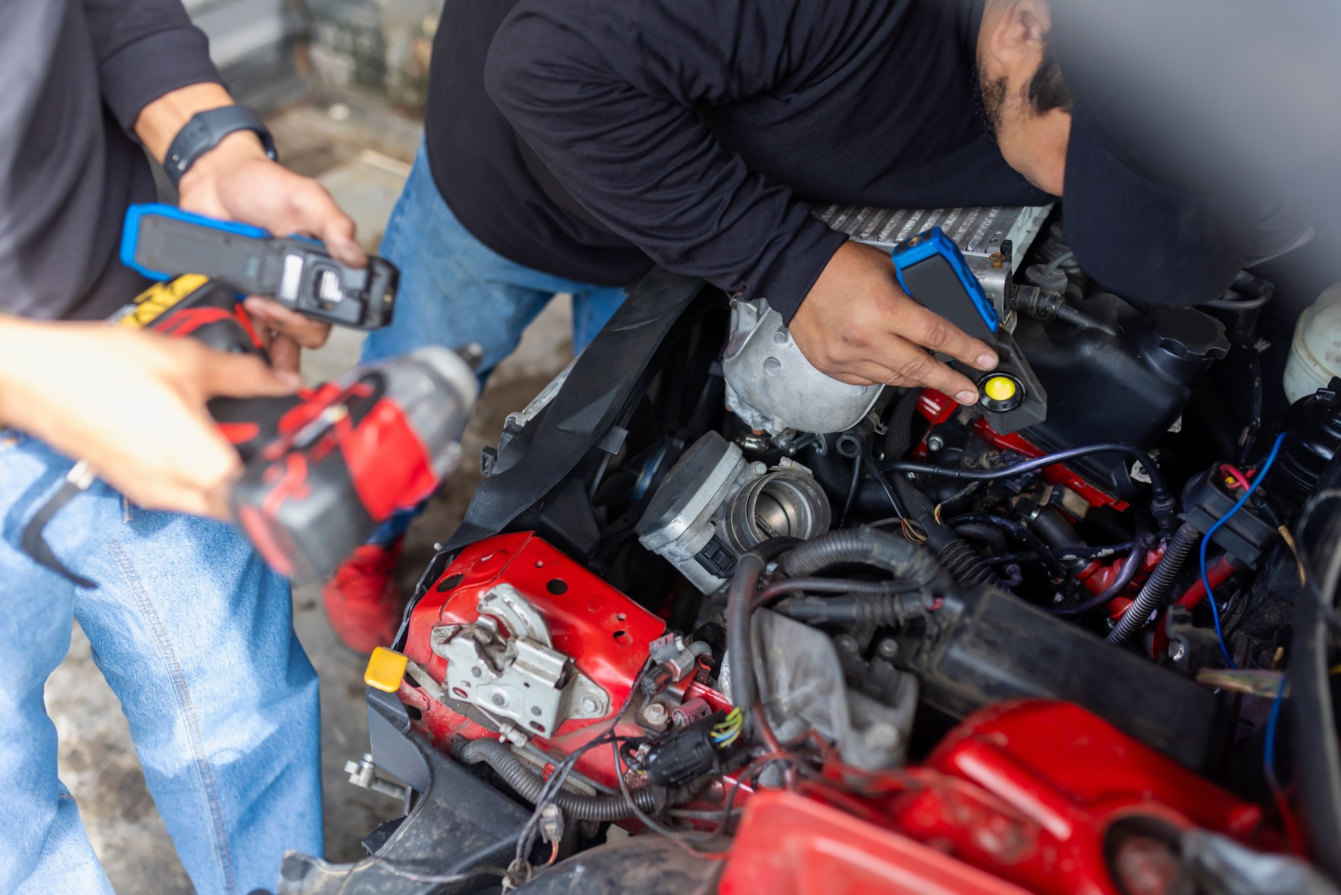 Mechanics checking and calibrating a car